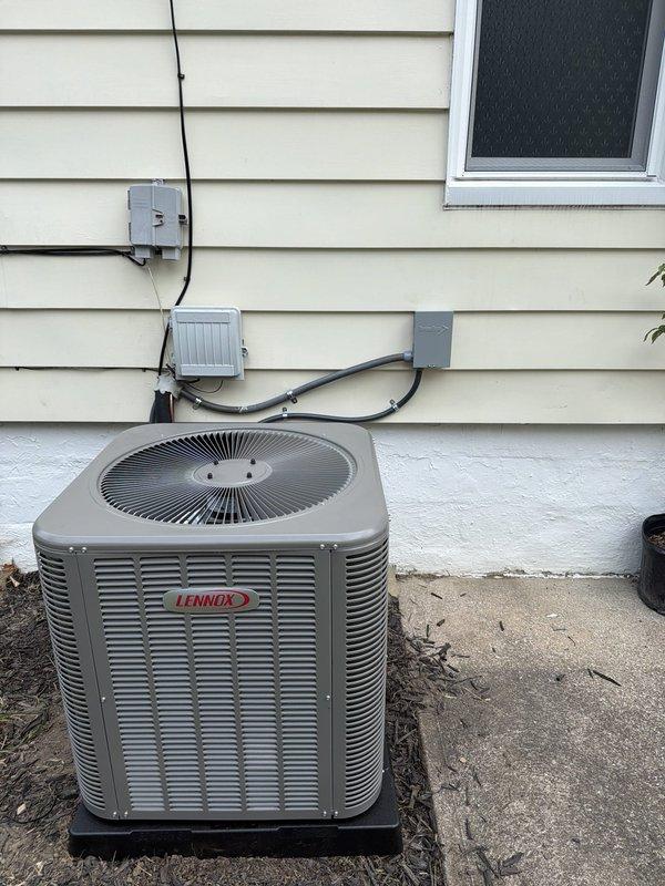 Completed first-time installation of new Lennox air conditioning condensing unit with matching evaporator coil system. Installed outdoor unit on concrete pad with proper electrical connections including disconnect box, junction box, and weather-resistant components, verified FLNR 254 CLASS RK5 Littelfuse fuses properly seated in disconnect, and established all required conduit runs per code requirements.