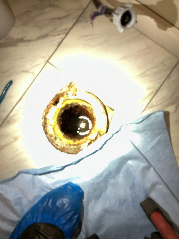 Responded to a hall bathroom drain blockage affecting a separate branch line in the drainage system. Upon arrival, found several inches of standing water in the bathtub and discolored water present in fixtures due to drain backup. The back pressure from the blocked line had compromised the toilet's wax seal, causing water to leak onto the bathroom floor with potential seepage into the crawl space below. 

Evacuated standing water from both the bathtub and toilet bowl to prepare for drain clearing operations. Removed and set aside the toilet to access the drain line directly. Deployed mechanical snake through the exposed drain opening to locate and clear the obstruction in the branch line. Successfully broke through the blockage and restored proper drainage flow throughout the affected branch line. 

Verified clearance by running water through the system and confirming adequate flow with no backup. Reinstalled the toilet with a new wax ring seal from truck stock to ensure proper waterti