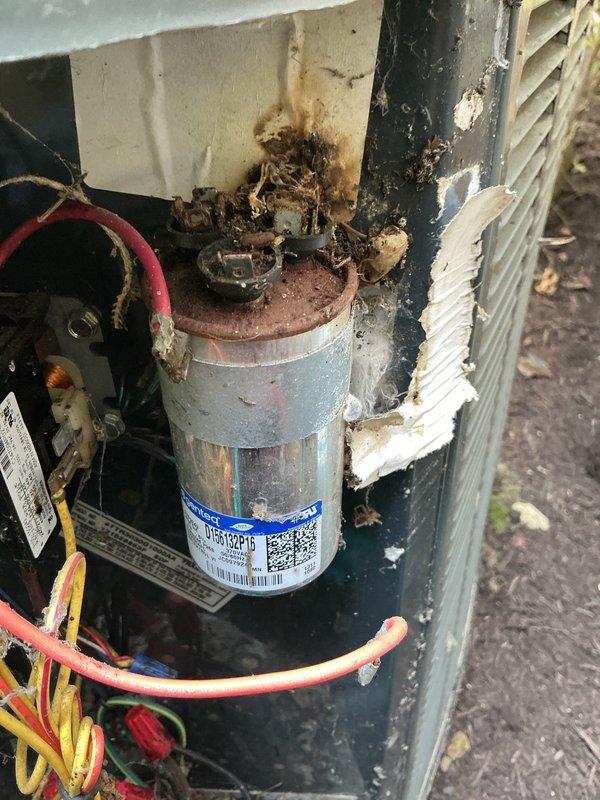 # HVAC Service Summary

Performed preventive maintenance on 8-year-old air conditioning system. Upon inspection, discovered failed capacitor with severe corrosion and thermal damage to housing and surrounding components. Replaced defective capacitor with new Totaline P291-4054R5 dual-run capacitor rated for 370/440VAC operation. Cleaned debris and corrosion from capacitor mounting area, verified all electrical connections, and tested system operation to confirm proper functionality.

# Detailed Service Description

Responded to service call for existing customer's outdoor air conditioning unit, approximately 8 years old and originally installed by our company. Arrived on-site and performed comprehensive system inspection of the condensing unit.

During visual inspection, identified a severely failed run capacitor exhibiting extensive corrosion, thermal damage, and burnt organic debris accumulation on top of the component and surrounding housing. The capacitor showed clear signs of elec