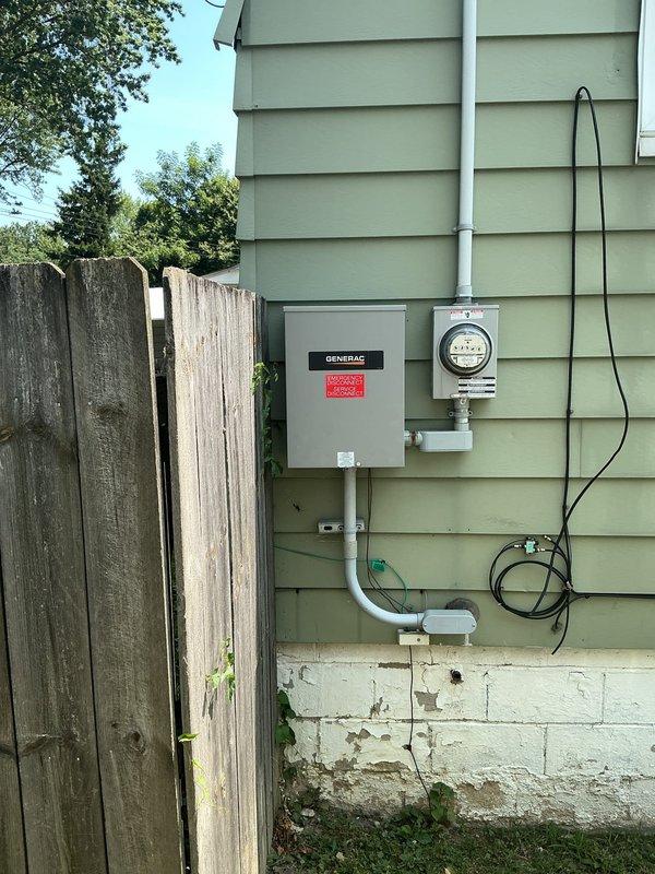 Disconnected and temporarily removed Generac standby generator to accommodate home addition construction. Capped natural gas line at interior connection point, removed exterior gas piping to generator unit, and disconnected electrical whip from transfer switch to generator. Generator and concrete pad relocated to back corner of property for storage during remodel phase, with future reinstallation and relocation to be quoted upon completion of addition.
