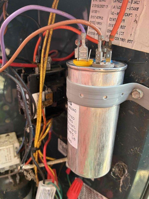 Diagnosed dual capacitor with compressor side reading out of acceptable range, which could cause premature compressor failure and eventual loss of cooling. Replaced defective dual run capacitor with truck stock unit to restore proper electrical specifications and prevent equipment damage. System tested and verified operating within normal parameters following repair.