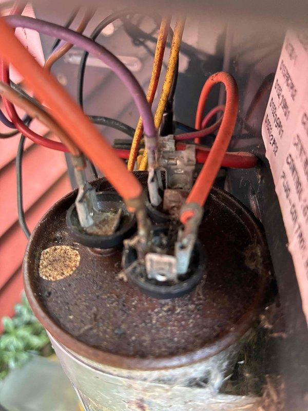 Diagnosed dual capacitor with compressor side reading out of acceptable range, which could cause premature compressor failure and eventual loss of cooling. Replaced defective dual run capacitor with truck stock unit to restore proper electrical specifications and prevent equipment damage. System tested and verified operating within normal parameters following repair.