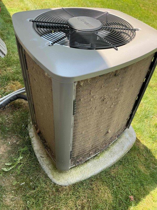 Completed BS-MVP cooling maintenance visit on outdoor condensing unit. Performed standard preventive maintenance procedures including inspection of condenser coils, which showed significant accumulation of dirt and debris on exterior panels and filter screens. Unit operational and positioned on concrete pad with proper clearances maintained. Documented equipment condition through photographic records showing weathering and soil buildup requiring attention during service visit.