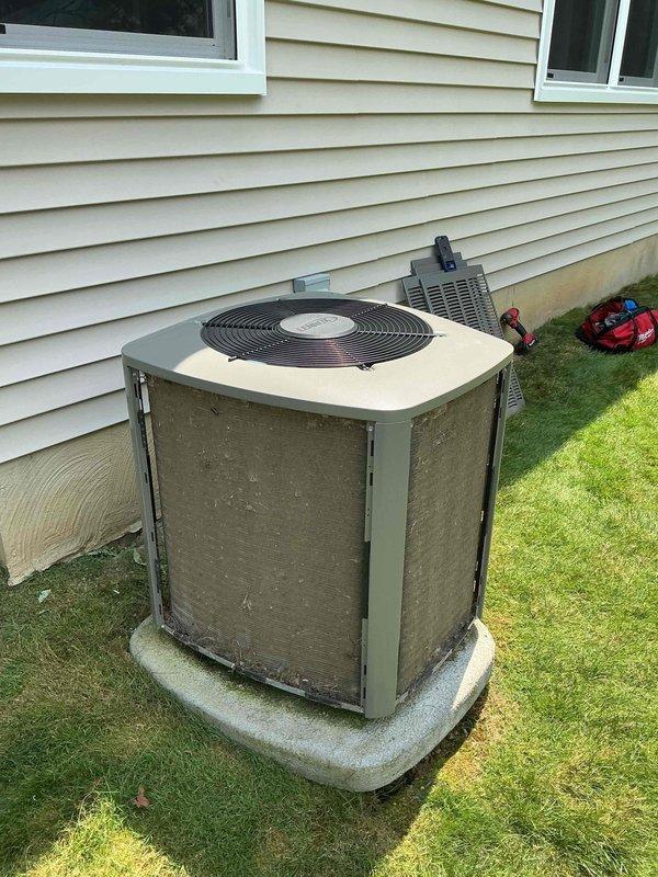Completed BS-MVP cooling maintenance visit on outdoor condensing unit. Performed standard preventive maintenance procedures including inspection of condenser coils, which showed significant accumulation of dirt and debris on exterior panels and filter screens. Unit operational and positioned on concrete pad with proper clearances maintained. Documented equipment condition through photographic records showing weathering and soil buildup requiring attention during service visit.
