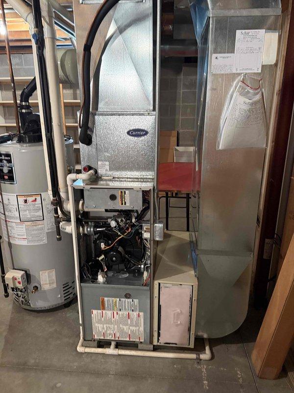 Completed installation of a 90% efficiency Carrier furnace and air conditioning system in basement mechanical room. Installed new furnace unit with integrated blower motor assembly, connected ductwork transitions, and completed all electrical wiring and controls. Verified proper system operation, tested refrigerant charge at service ports, and confirmed all mechanical components functioning within manufacturer specifications.