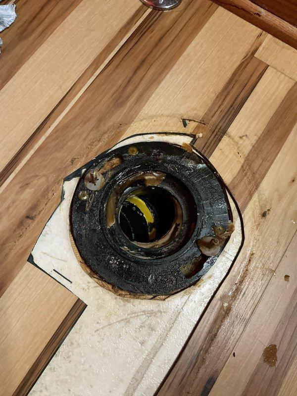 Responded to report of toilet leaking at base during flushing. Upon inspection, confirmed water seepage around toilet base and discovered severely corroded toilet flange with significant rust buildup and deterioration. Removed toilet, replaced failed wax ring seal, and installed new toilet flange assembly. Reinstalled toilet with proper sealing and verified leak-free operation through multiple flush cycles.