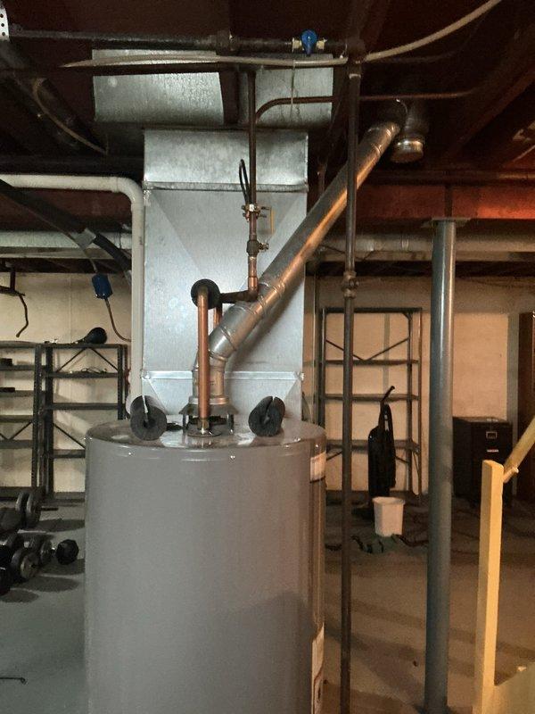 Provided estimate for conversion from existing 40-gallon gas water heater to 10-gallon electric unit in basement utility area of 1958-built residence. Assessed current installation including gas supply line, venting system, and existing plumbing connections with copper piping. Estimate includes disconnection and removal of gas water heater, capping of gas line per code requirements, installation of appropriate electrical circuit and wiring for electric unit, reconfiguration of water supply and discharge piping to accommodate smaller capacity tank, and proper mounting and connection of new electric water heater with required temperature and pressure relief valve and discharge piping.
