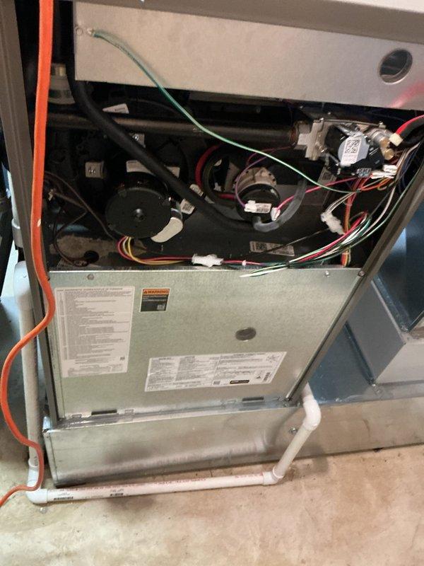 Responded to service call for loud roaring noise upon unit startup with error code 002A/A200 and blinking red light indicator. Performed diagnostic inspection of furnace system, removed and inspected air filter which showed standard pleated media condition, and accessed interior cabinet to examine blower motor assembly, wiring harnesses, control boards, and electrical connections for fault identification related to reported error code and abnormal operating sounds.