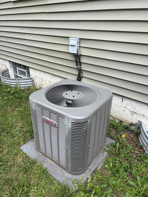 Performed seasonal tune-up on 9-year-old Lennox air conditioning system. Conducted standard maintenance inspection including temperature differential testing, which showed proper cooling performance at 52°F supply air temperature. System operating within normal parameters with no issues identified during visual inspection of outdoor condensing unit and electrical connections.