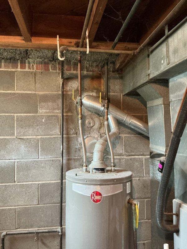 Responded to main drain backup occurring during shower use with gurgling sounds reported. Upon arrival, inspected bathroom shower area and basement plumbing system including water heater connections and drainage lines. Performed diagnostic assessment of main drain line to identify blockage causing backup. Cleared obstruction from main drain cleanout, restoring proper drainage flow and eliminating gurgling sounds in the system.