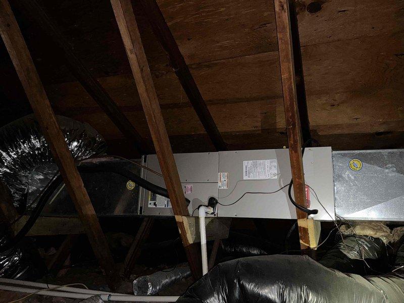 Completed estimate for second floor furnace and air conditioning replacement in attic location. Assessed existing horizontal air handler unit with associated ductwork in confined attic space with limited access via steps. Documented current HVAC system configuration including air handler positioning, flexible duct connections, and electrical components. Evaluated installation area constraints and provided replacement options for packaged unit system suitable for the restricted workspace and existing infrastructure.