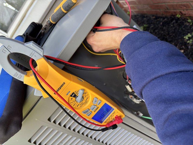 Performed scheduled MVP cooling maintenance visit on residential outdoor condensing unit. Conducted comprehensive electrical diagnostics using digital multimeter to verify system performance, tested voltage and amperage at control board and electrical connections. Inspected condenser unit components, verified proper operation of fan motor and compressor, and confirmed all electrical connections were secure within the unit's control panel.