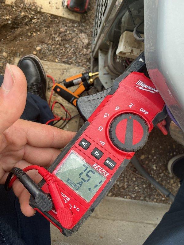 Completed MVP recurring cooling maintenance visit on residential HVAC system. Performed comprehensive system diagnostics including temperature differential measurements at supply register, recording 65°F air temperature at floor-level vent. Conducted electrical testing on outdoor condensing unit using digital multimeter, measuring 15.4 volts at system components to verify proper electrical operation. Inspected return air ventilation showing moderate dust accumulation on grille, typical for residential system requiring routine filter maintenance. All critical system parameters checked and operating within normal specifications for continued cooling performance.