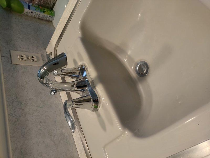 Completed replacement of two faucets in the home. Replaced utility sink faucet in basement with similar style unit, banding onto existing water lines. Installed new Moen two-handle faucet in chrome finish at upstairs hallway bathroom, including replacement of angle stops with new 1/4 turn units, new supply lines, and complete pop-up drain assembly replacement.