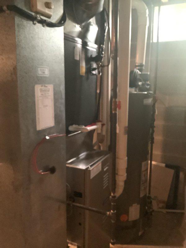 Completed furnace replacement estimate for 21-year-old heating system. Documented existing installation including furnace unit, water heater, ductwork configuration, humidifier integration, and copper piping layout in basement utility space. Photographed current equipment conditions and mechanical room setup to provide comprehensive assessment for system replacement recommendations.
