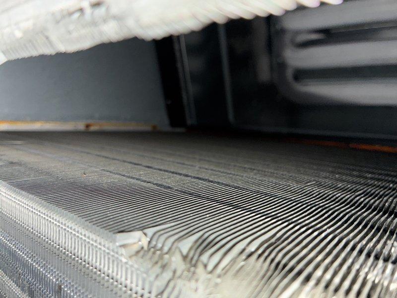 Completed comprehensive air conditioning tune-up service including visual inspection of evaporator coil assembly and heat exchanger components. System components showed normal operational wear with some dust accumulation; all major elements including refrigerant lines, coil fins, and electrical connections were assessed and found to be functioning within acceptable parameters.