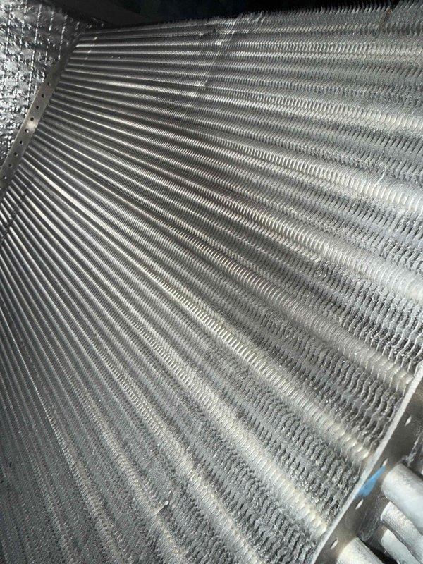 Completed comprehensive MVP cooling maintenance visit on residential HVAC system. Performed visual inspection of evaporator coil assembly, noting normal dust accumulation on aluminum fins consistent with standard operation. Verified proper fin spacing and structural integrity throughout coil section. Inspected Aprilaire humidifier control unit mounted on system panel, confirmed operational settings and wiring connections secure. Documented equipment condition through photographic records for service history. All system components found functioning within normal parameters.