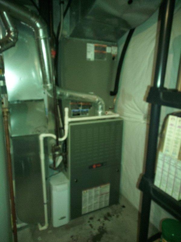 Completed installation of new air conditioning system and evaporator coil in residential mechanical room. System was charged with R454B refrigerant and tested using digital manifold gauges, confirming proper superheat reading of 15.6°F and subcooling of 126°F, with operating pressures of 180 psi low side and 249 psi high side, indicating optimal system performance.
