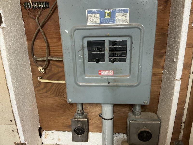 Conducted site assessment for mini split installation in well-insulated garage woodworking shop. Evaluated existing electrical infrastructure including Square D load center with available breaker capacity and confirmed adequate 8/3 wiring at 130 amp service for system requirements. Documented workspace layout, ceiling structure with exposed concrete and fluorescent lighting, and optimal placement considerations for indoor and outdoor unit installation to ensure efficient climate control for the active workshop environment.