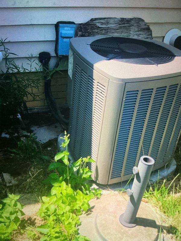 Completed MVP cooling maintenance visit on 10-year-old system. Upon arrival, found outdoor condenser unit with heavily soiled condenser coil exhibiting significant debris accumulation including dirt, dust, plant materials, seed pods, and dried grass fragments restricting airflow through fins. Performed thorough cleaning of condenser coil to restore proper heat exchange efficiency and airflow. Documented unit condition with photos showing before state and installation environment. System operational upon completion of maintenance service.