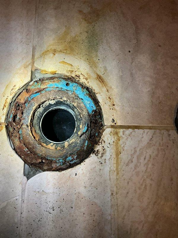 Completed toilet replacement in 40-year-old residential property. Removed existing two-piece toilet fixture from powder room with burgundy walls and beige ceramic tile flooring with decorative border trim. Disconnected water supply line and unbolted toilet from floor flange. Hauled away old toilet per customer request. Inspected floor flange and wax ring seat for proper condition. Installed customer-supplied white porcelain two-piece toilet with chrome flush handle. Secured unit to floor flange with new closet bolts and wax ring seal. Reconnected water supply line and tested for proper flush operation and leak-free connections. Verified proper bowl water level and tank refill function. Cleaned work area and confirmed satisfactory installation with customer.