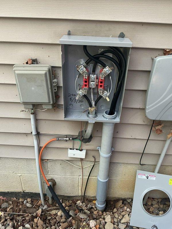 Coordinated with power company for underground service disconnection to facilitate meter base and conduit repair. Removed existing meter base and damaged conduit section, cutting pipe near ground level to install new expansion coupling. Rebuilt 2" PVC conduit riser from ground to meter base, reconnecting all components and adjusting meter base height to accommodate existing wire length. Installed new grounding electrode system with ground rods while maintaining existing waterline ground connection. Completed same-day inspection for utility company to restore underground service and reconnect power.