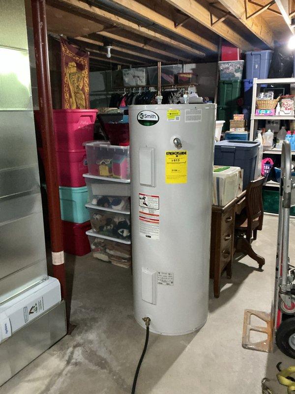 Completed installation of new A.O. Smith tanked water heater in basement utility area. Drained and removed old water heater from premises per customer request. Repaired leaking elbow joint on blower condensate line running to sump pump. All plumbing connections tested and verified operational with no leaks detected.