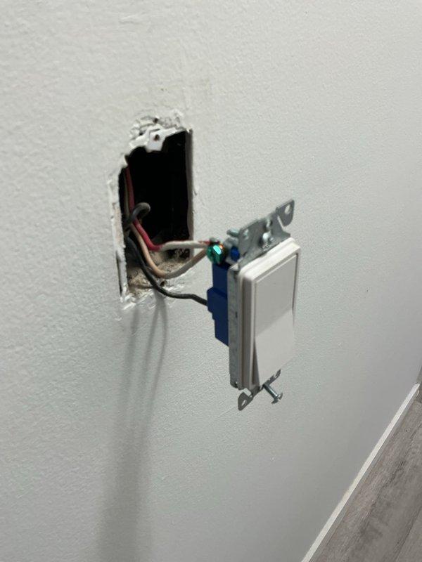 Corrected miswired 3-way switch in hallway by identifying and properly reconnecting swapped traveler and common wires to restore full functionality from both switch locations. Modified three bedroom switched outlets by breaking tabs and rewiring to provide constant power to half of each receptacle while maintaining switched control on the remaining half. Installed old work electrical boxes with new outlets for microwave and above-cabinet locations, including fishing wire through wall cavity and properly terminating romex connections to replace existing cord-end configurations.
