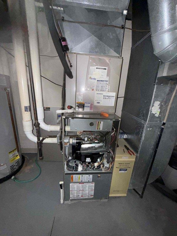 Responded to no cooling complaint on aging residential air conditioning system. Upon inspection, confirmed compressor failure with unit unable to produce cool air. Accessed outdoor condensing unit and indoor furnace components to diagnose issue. Tested capacitor (marked as 45 MFD) and verified electrical connections to compressor. System age estimated at 10+ years or older, indicating equipment is near or beyond expected service life. Documented equipment condition with photos showing furnace interior, blower assembly, and capacitor installation. Advised customer that compressor replacement may not be cost-effective given system age and recommended evaluation for complete system replacement.