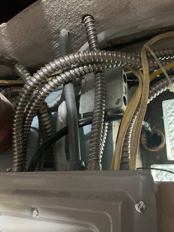 Installed new 480-volt AC circuit with proper conduit routing and panel integration. Ran metallic flexible conduit from breaker panel to AC unit location, securing all runs to structural elements per code requirements. Updated panel directory with clear circuit identification and verified all connections for proper voltage and load capacity.