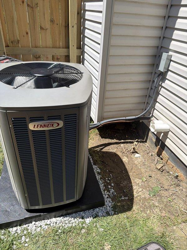 Completed full HVAC system installation including 90% efficiency furnace, air conditioning condenser unit, and humidifier following warranty service call. Installed Lennox brand outdoor condensing unit on rubber isolation pad with proper gravel base for drainage, mounted refrigerant lines to exterior wall with secure brackets, and replaced 30-amp Littelfuse disconnect assembly. System commissioned and verified operational with all components functioning to manufacturer specifications.