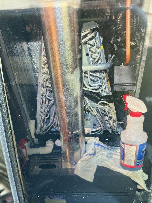 Responded to service call for 2-year-old air conditioning system experiencing continuous operation and refrigerant line freezing. Upon inspection, measured system pressures using manifold gauges and identified low refrigerant charge causing evaporator coil to ice over. Accessed air handler unit, confirmed frozen evaporator coil and condensate drainage system functionality. Applied appropriate cleaning solution to affected components and allowed system to thaw completely before further diagnostics.