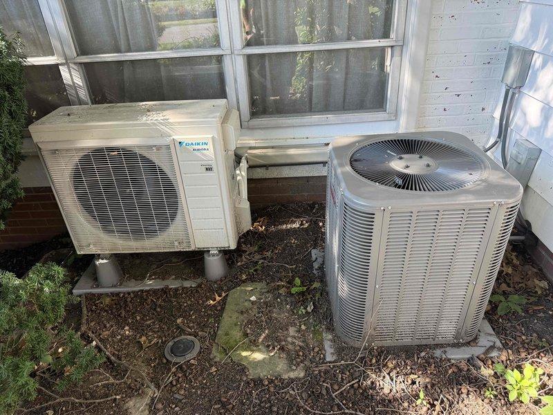 Completed routine HVAC maintenance visit for MVP customer with 6-year-old outdoor air conditioning system. Performed standard inspection of dual condenser units, including visual assessment of Daikin unit and secondary condenser, examined evaporator coil fin condition, and documented equipment status through photographic records for service history.