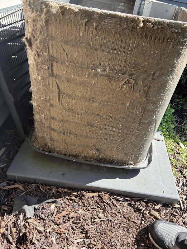 Completed BS-MVP cooling maintenance visit on 7-year-old outdoor unit. Removed and documented severely clogged air filter with extensive dirt and debris accumulation throughout pleated media. Inspected electrical components including capacitor, wiring connections, and control terminals. All electrical connections verified secure with proper color-coded wiring intact. System operational following filter replacement and standard maintenance procedures.