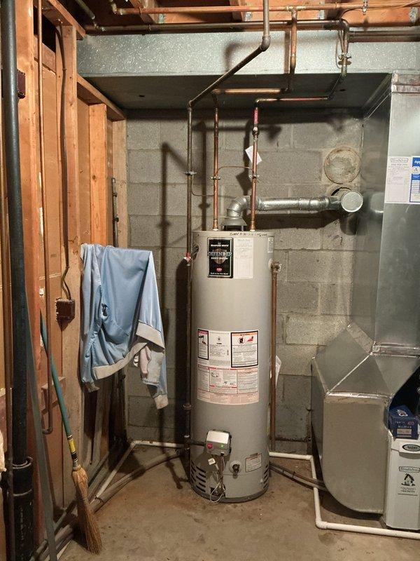 Completed comprehensive 26-point plumbing inspection on 47-year-old residential property equipped with private well water system and multi-tank water treatment setup installed in January 2020. Inspected gas-fired water heater located in basement utility area, verifying proper copper piping connections, temperature/pressure relief valve operation, and venting system integrity. Evaluated complete water treatment system consisting of multiple filtration tanks with digital control panel, pressure tank, and associated plumbing connections to ensure proper operation and settings since original installation. Assessed all visible copper supply lines, drainage systems, fixtures, and plumbing components throughout accessible areas of the home. Verified water pressure levels, checked for signs of leaks or corrosion on exposed piping, and confirmed proper function of well system components. Documented current condition of all major plumbing infrastructure with photographic evidence for maintenance
