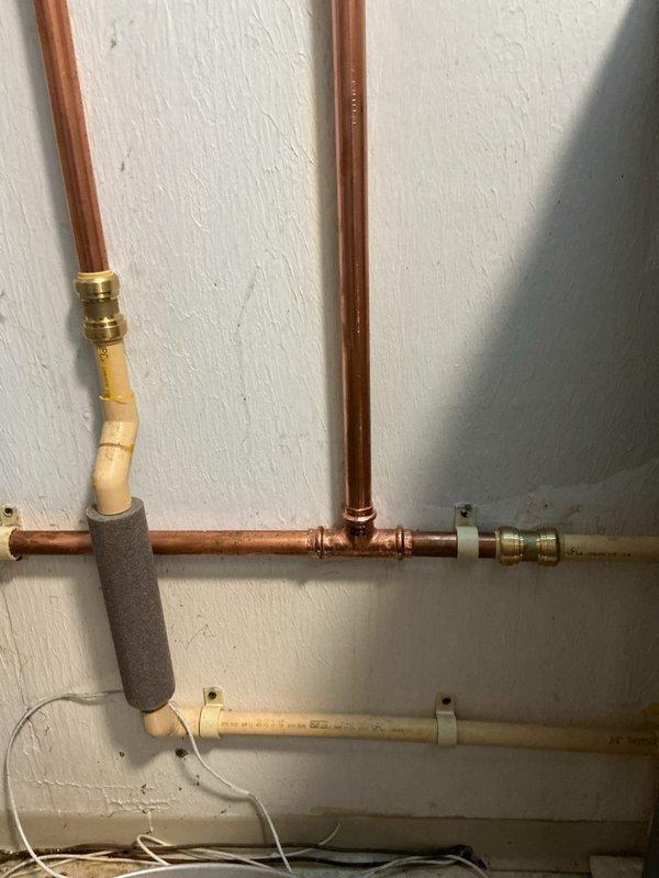 Replaced existing water heater with new 40-gallon tall Bradford White tank water heater including 8-year tank warranty. Installation included new water shut-off valve and thermal expansion tank to protect against pressure buildup in the system. Installed pressure reducing valve near the water meter to regulate incoming water pressure. Replaced second shut-off valve and installed tee connection for trap primer. All copper piping connections completed with brass fittings to ensure proper water flow and system integrity. Parts were coordinated for delivery and staged prior to installation. Required two-person crew for safe removal of old water heater unit.