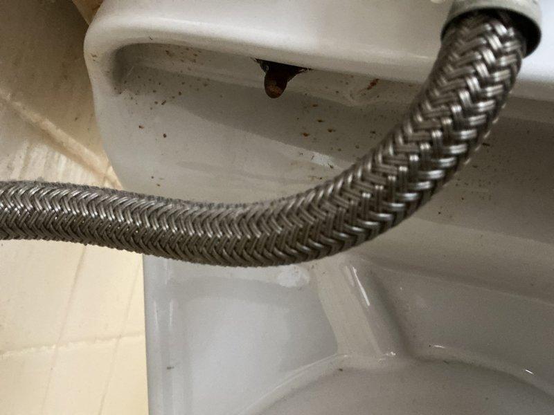 Responded to water leak complaint affecting toilet tank and kitchen sink faucet. Inspected toilet assembly and supply connections, identifying leak source at tank components. Replaced braided stainless steel supply line to toilet, ensuring proper connection at shutoff valve and fill valve inlet. Performed flush and fill procedure on tanked water heater to remove sediment buildup and restore optimal performance. Verified all connections for leaks, confirmed proper toilet operation, and ensured water heater functionality upon completion.