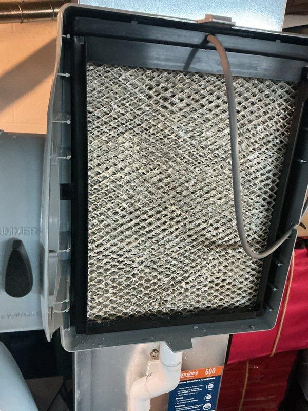 Performed comprehensive tune-up on 12-year-old air conditioning system with no reported issues. Inspected outdoor unit, tested system performance with digital gauges reading 660 PSI, and documented severely clogged air filter requiring immediate replacement due to heavy dust and debris accumulation restricting airflow. Replaced dirty filter, verified proper blower activation on Aprilaire humidifier control, checked refrigerant levels, and confirmed all system components operating within normal parameters.