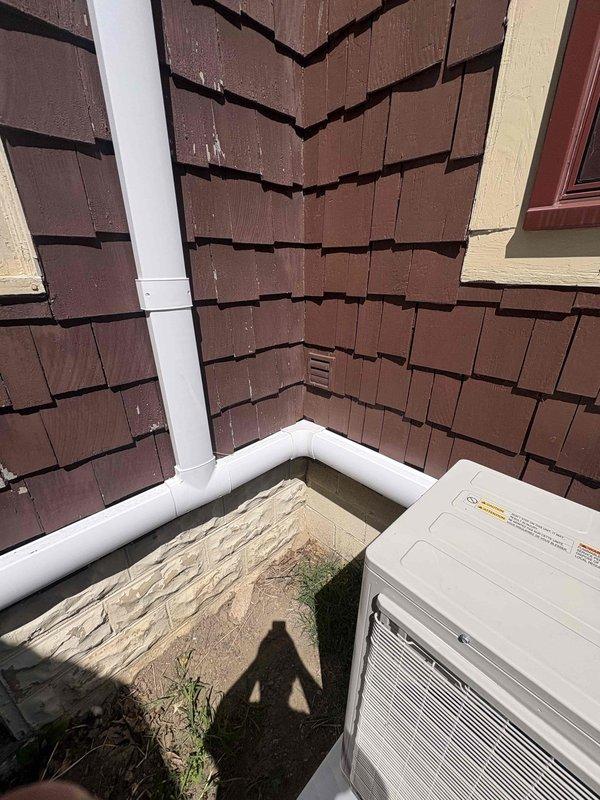 Returned to site to properly rehang mini-split head unit that required repositioning. Corrected condensate drain line routing and secured refrigerant line set with appropriate line hide covering for improved aesthetics and protection. Utilized ladder to access elevated installation point on building exterior. Verified proper drainage function and ensured all refrigerant lines were adequately concealed and secured to exterior wall per manufacturer specifications. System tested and confirmed operational upon completion of warranty corrections.
