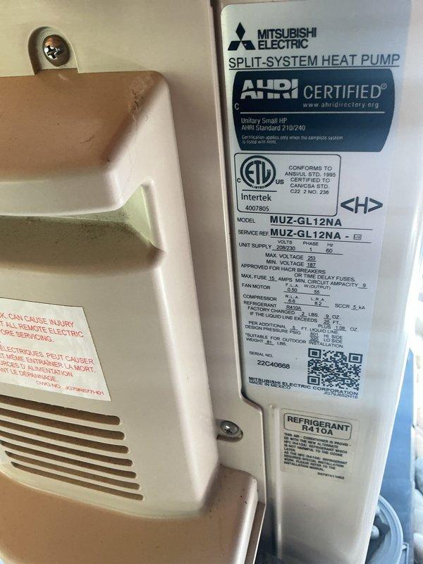 Completed comprehensive tune-up on Mitsubishi Electric split-system heat pump (Model MUZ-GL12NA) located at rear of property. Performed internal inspection of wall-mounted unit, verified operational temperature readings at 55.5°F, and confirmed all system components, labels, and safety warnings are intact and functioning properly.