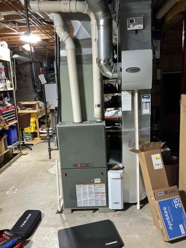 Performed annual maintenance on 12-year-old air conditioning system. Inspected indoor furnace and air handler components, verified proper condensate drain line operation, and checked all accessible ductwork connections. Proceeded to outdoor condensing unit where access panel was removed to inspect electrical components including capacitor, contactor, and associated wiring harnesses. Tested system operation, verified proper electrical connections, and cleaned debris from unit base. All components found operating within normal parameters and system returned to service.