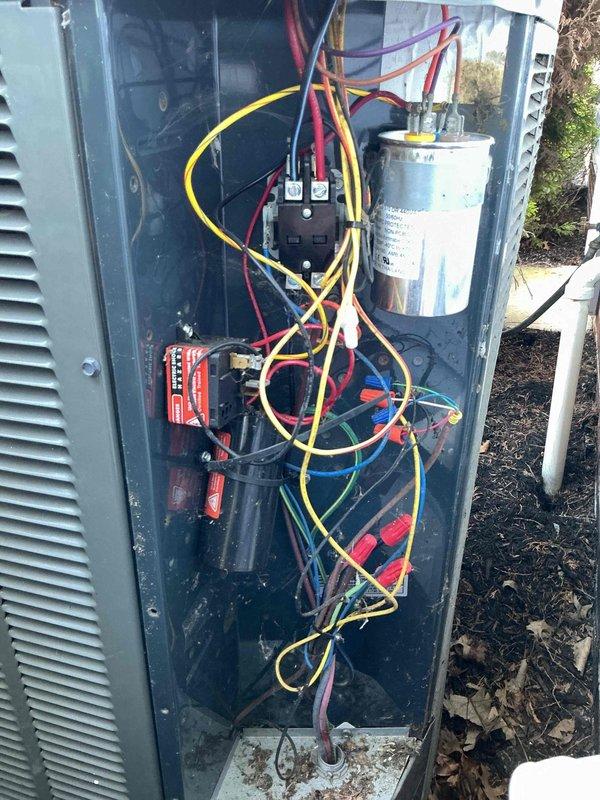 Performed annual maintenance on 12-year-old air conditioning system. Inspected indoor furnace and air handler components, verified proper condensate drain line operation, and checked all accessible ductwork connections. Proceeded to outdoor condensing unit where access panel was removed to inspect electrical components including capacitor, contactor, and associated wiring harnesses. Tested system operation, verified proper electrical connections, and cleaned debris from unit base. All components found operating within normal parameters and system returned to service.