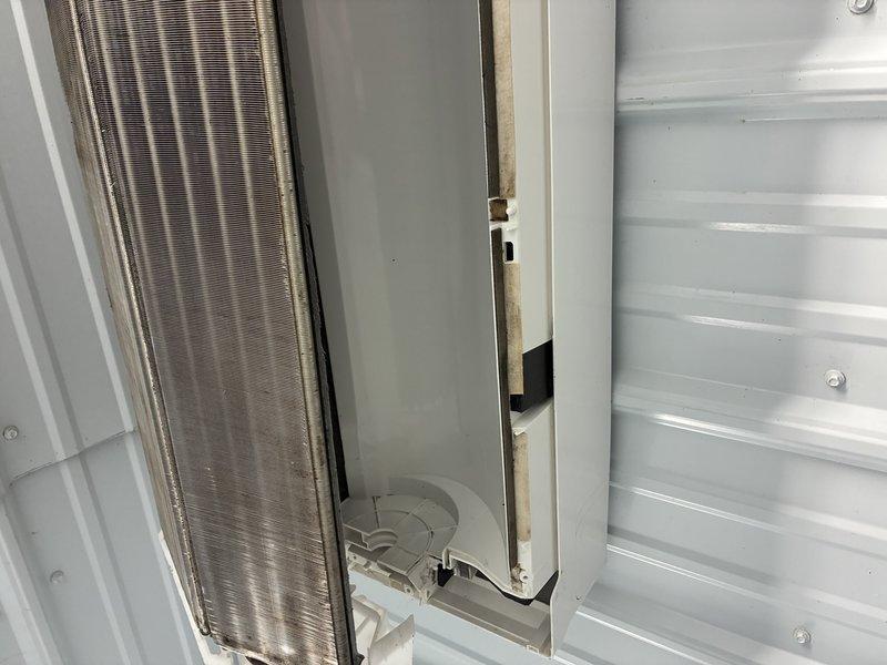 Responded to recurring refrigerant leak on mini split system that was previously addressed. Upon inspection, discovered significant mold growth and contamination on evaporator coil and interior cabinet surfaces, with visible brown and black discoloration indicating moisture intrusion. Documented extensive biological growth on mounting surfaces and deteriorated conditions around heat exchanger components, confirming ongoing water leak issue causing damage to internal components and requiring immediate remediation.