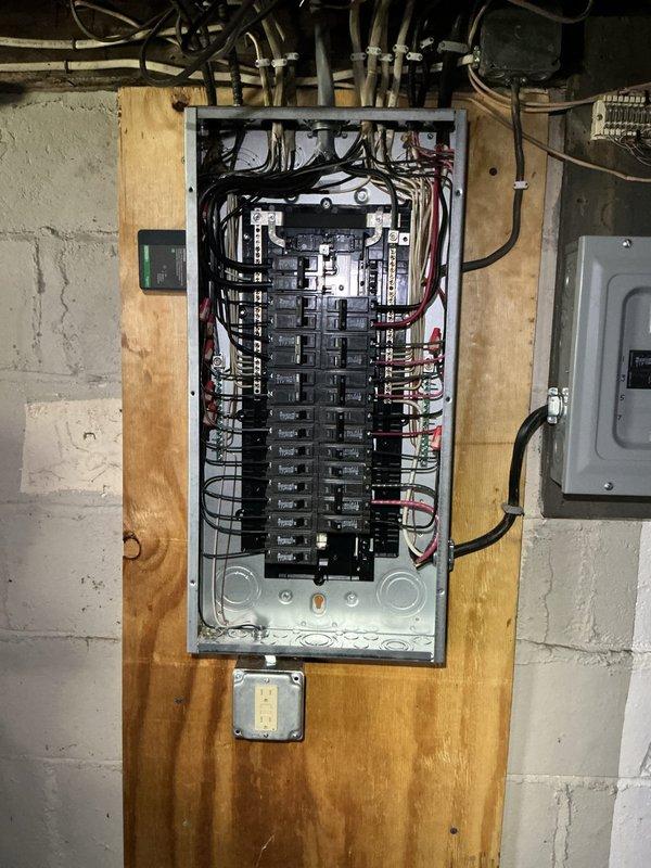 Completed 100-amp electrical service upgrade in compliance with 2023 National Electrical Code requirements, including necessary grounding system updates and installation of exterior disconnect switch. Installed new main electrical panel with proper circuit breaker configuration and wire management, mounted on plywood backing board in basement utility area. Added whole home surge protection device to safeguard electrical system and connected appliances from voltage spikes and power surges.
