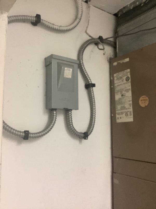 Completed HVAC estimate for package unit replacement at residential property. Assessed existing electrical infrastructure including junction box, disconnect switch, and flexible conduit routing. Documented current wiring configuration, wall cavity conditions, and equipment connections to provide accurate specifications for 8-ton package unit replacement system.