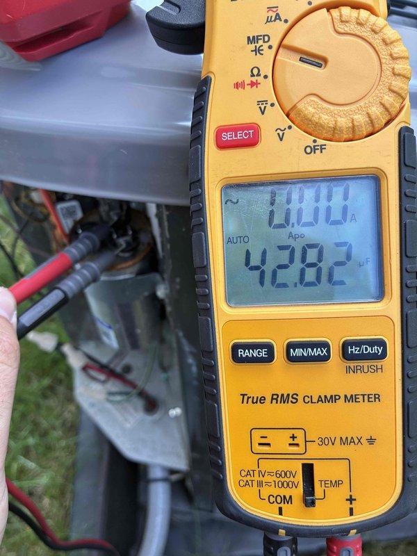 Completed preventive maintenance inspection on 3-year-old cooling system. Verified system operation with clamp meter showing 0.00A current draw and 42.82°F temperature reading at outdoor unit. Measured supply air temperature at 113.3°F at ductwork, confirming proper heat exchange and system performance within normal operating parameters for cooling mode.