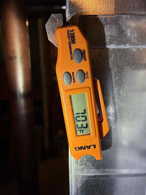 Completed preventive maintenance inspection on 3-year-old cooling system. Verified system operation with clamp meter showing 0.00A current draw and 42.82°F temperature reading at outdoor unit. Measured supply air temperature at 113.3°F at ductwork, confirming proper heat exchange and system performance within normal operating parameters for cooling mode.
