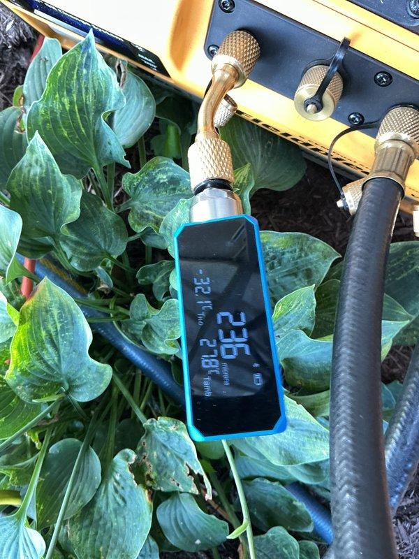 Responded to service call for insufficient cooling with indoor temperature reading 75°F when thermostat set to 72°F. Performed diagnostic testing on one-year-old air conditioning system using manifold gauges and digital measurement equipment. Found refrigerant charge at 23.6 PSI, indicating system was operating below optimal levels. Inspected outdoor condensing unit connections, indoor evaporator coil components, and refrigerant line set for leaks or restrictions. Added refrigerant to manufacturer specifications, verified proper system pressures and temperatures, and confirmed adequate cooling performance before departure.