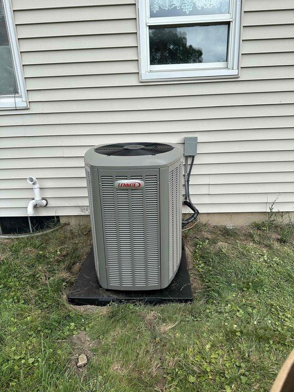 Completed full installation of new Lennox air conditioning system including outdoor condenser unit and indoor evaporator coil. Positioned condenser on level platform pad against exterior wall with proper clearances, ran electrical conduit and refrigerant lines, and installed new Honeywell digital thermostat for system control. Tested all components for proper operation, verified refrigerant charge, and confirmed system is cooling effectively.