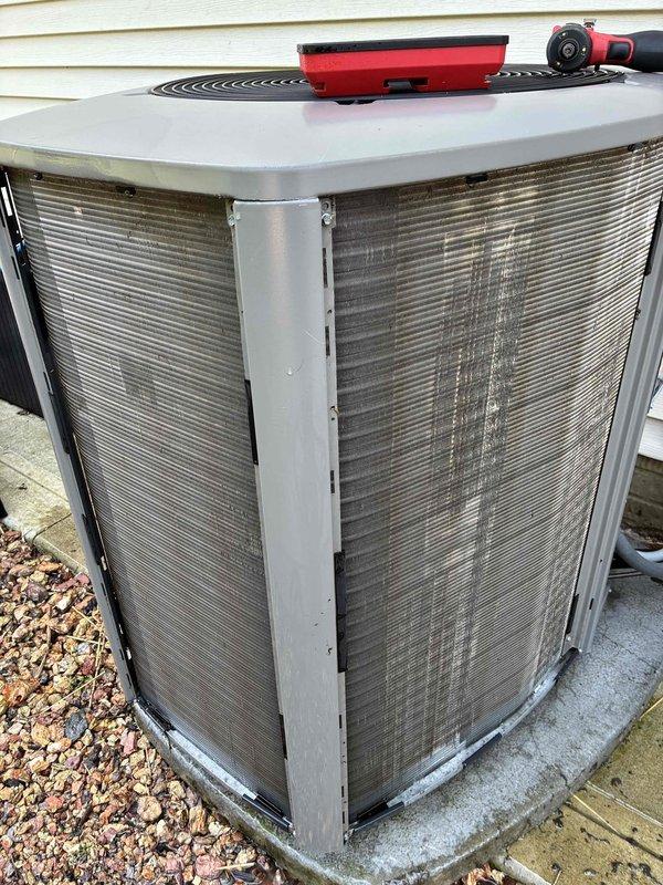 # HVAC Maintenance - Cooling Service

Completed routine cooling system maintenance on 6-year-old residential air conditioning unit. Performed comprehensive inspection of outdoor condenser unit, noting significant accumulation of dirt, dust, and debris on exterior mesh filters and coil surfaces. Cleaned condenser coils and protective grilles to restore proper airflow and system efficiency, addressing the heavy buildup that can restrict heat transfer and reduce cooling capacity. Verified unit operation, checked refrigerant levels, and ensured all components were functioning within normal parameters to maintain optimal performance throughout the cooling season.